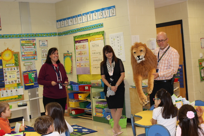 Mrs. Abreu earns the Lion's Pride Award. Presentation by Mr. Heller and Dr. Morillo.