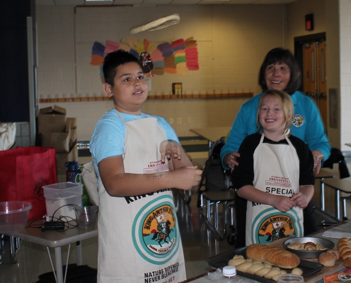 Hilltop students make dough to bake bread for themselves and to donate to a local food shelter.